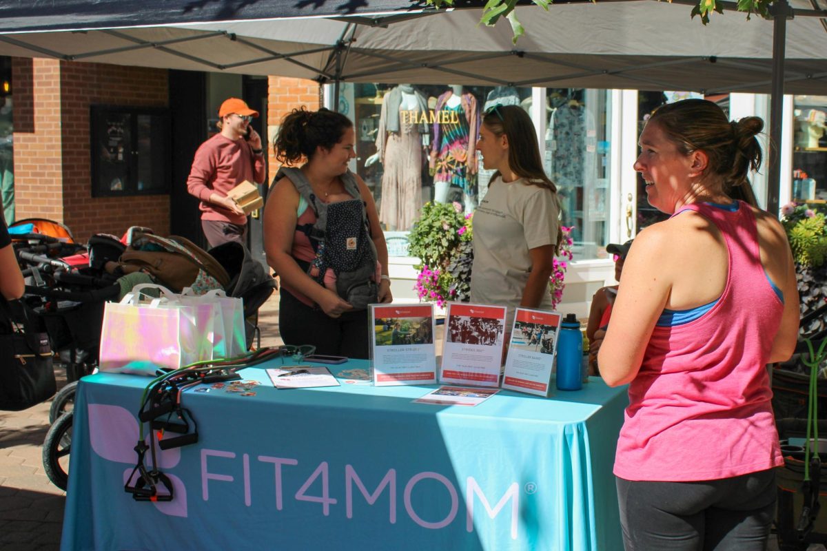 Nissa Lopez, one of two owners of FIT4MOM, talks to her co-owner Sept. 24.