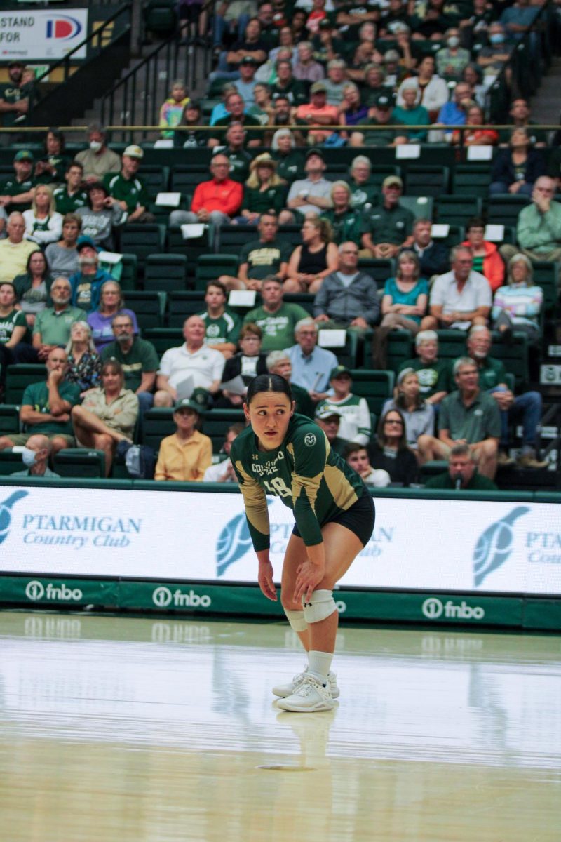 Kate Yoshimoto, a Colorado State University defensive specialist (18) looks back to watch the ball be served Sept. 28. Yoshimoto ended the game with a total of 15 digs making her the CSU leader.