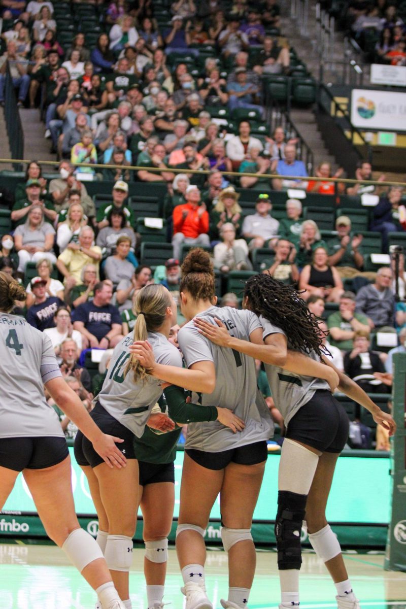 Anna Porter (10), Malaya Jones (1) and Naeemah Weathers (9) hug after scoring a point for Colorado State University Sept. 28.