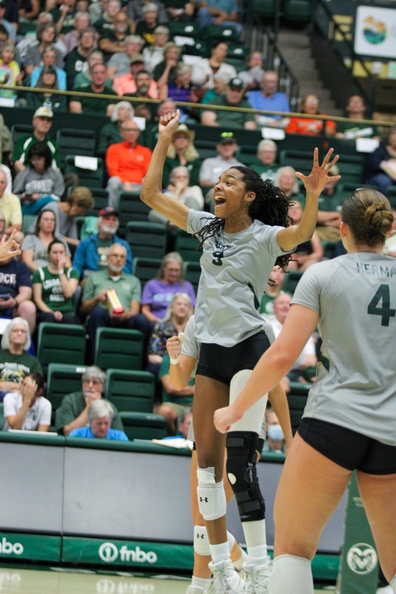 Colorado State University middle blocker Naeemah Weathers (9) celebrates her team after scoring another point Sept. 28. Weathers celebrates every point scored by her team by jumping and cheering.