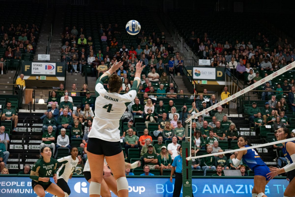 Colorado State University senior Emery Herman (4) sets the ball for her teammate to spike.