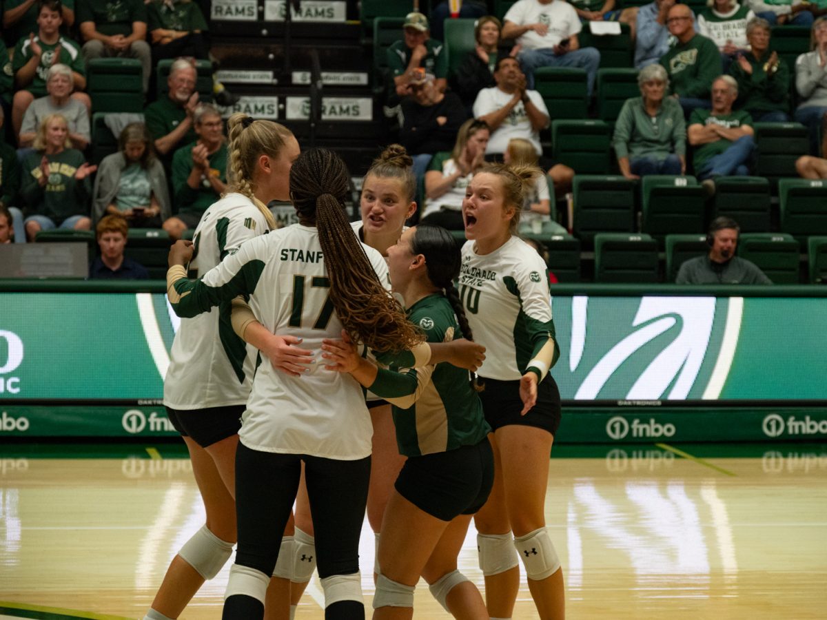 Colorado State University's volleyball players celebrate after a point.