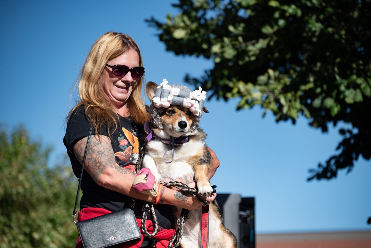 This Little Red Riding Hood-themed corgi and her owner stand for the judges of the Tour de Corgi costume contest.