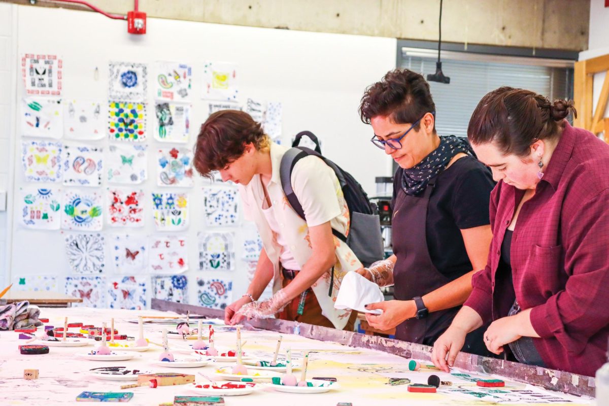 Professor Elnaz Javani guides students on how to create textile designs at Colorado State University’s second annual Artfest. “It’s been great, people are exploring all kinds of stamp painting and creating their own textile designs,” Javani said.