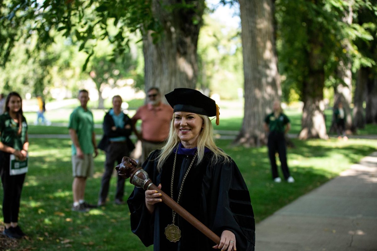 Newly invested President Amy Parsons holds the Colorado State University mace following her fall address Oct. 4. President Parsons greeted many friends, colleagues, and family after her speech at the Oval.