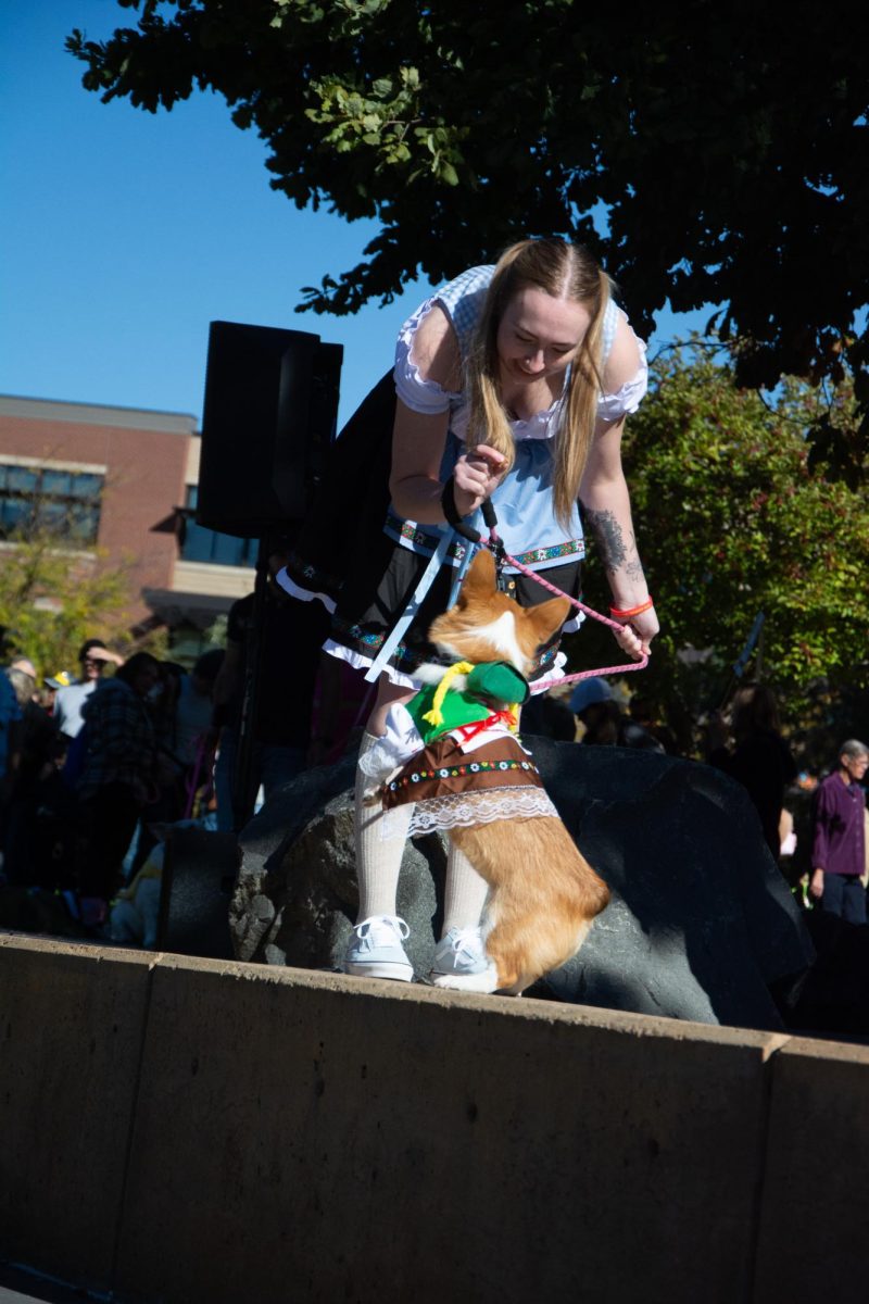 An owner and her dog dress up as a version of Oktoberfest (Corgtoberfest) during the costume contest. (Oct. 7) 