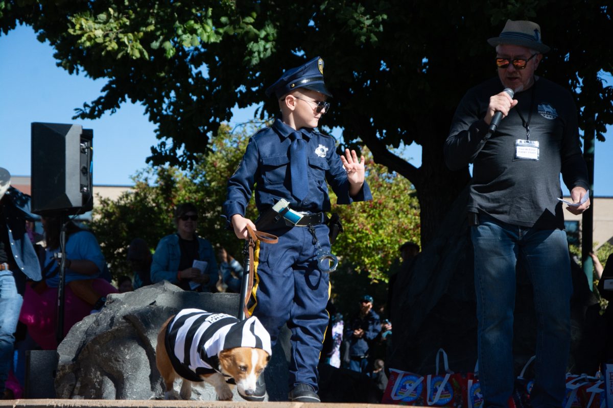 A young boy dressed as a police officer walks across the runway with his prisoner corgi in the "baddest to the bone" category during the costume contest. (Oct 7)