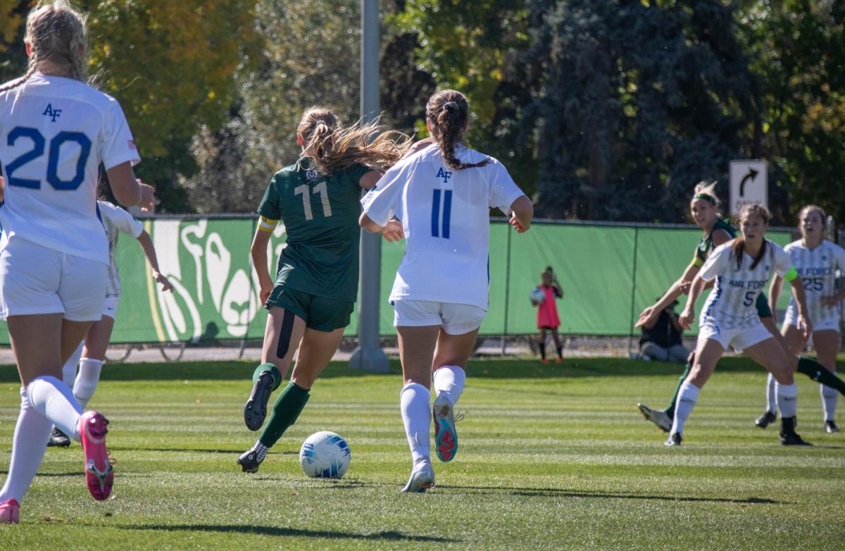 Kaitlyn Abrams (11) dribbles the ball past three Air Force Academy players on October 15. Kaitlyn is the programs leader in matches played with over 77 games played.