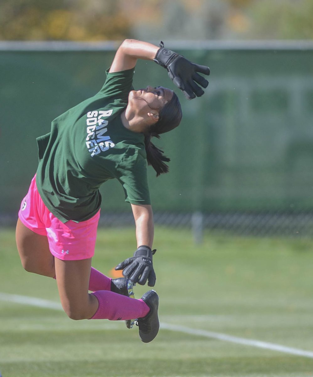 Libby Brooker (1) jumps to save the ball from going into the goal during warm ups against the United States Air Force Academy Oct 15.