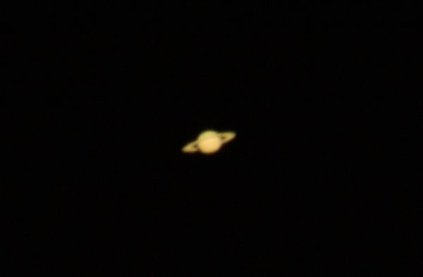 Planet Saturn stands out against a black sky.