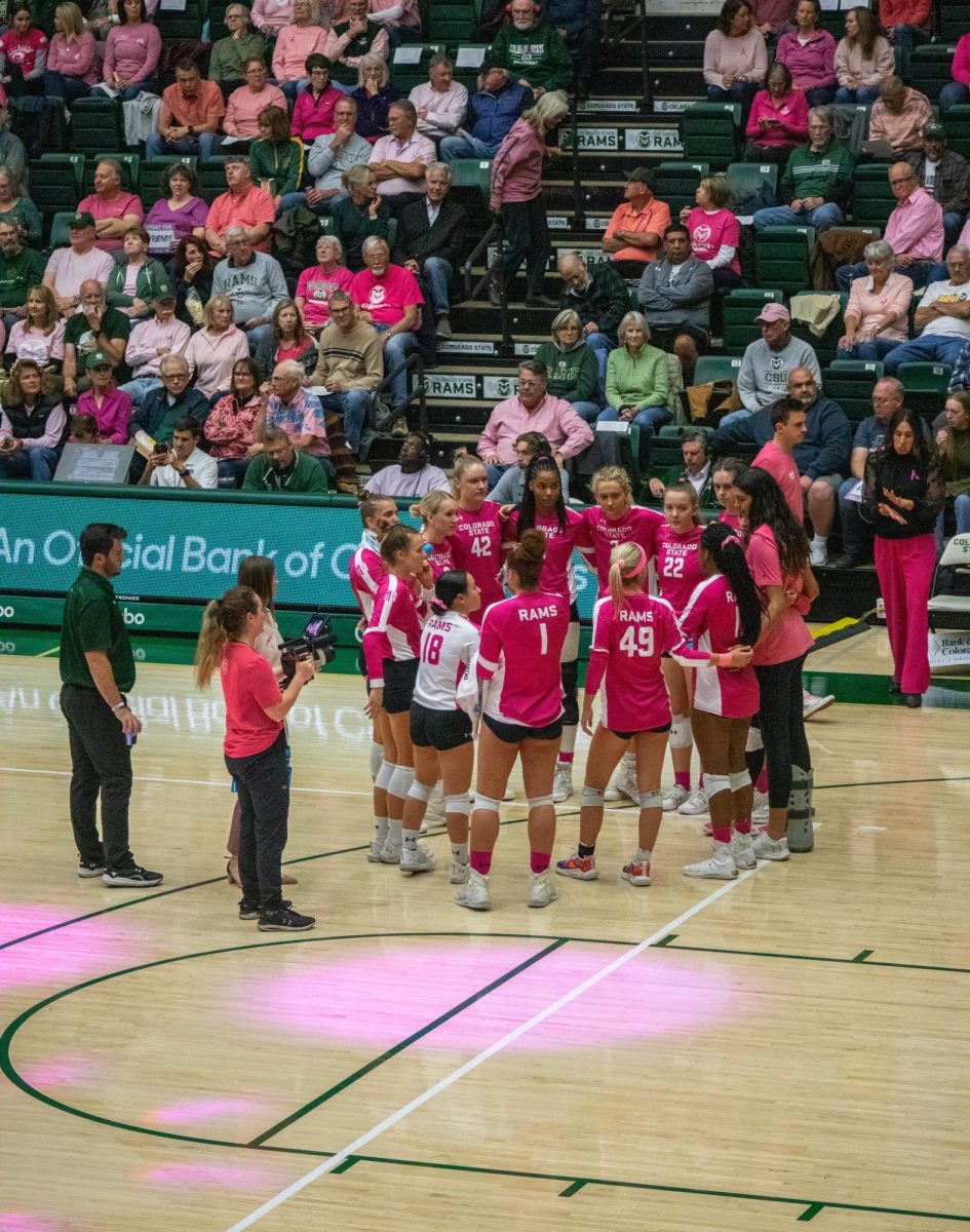 Colorado State Univeristy Volleyball players huddle together during a timeout in the second match. CSU dominated the first two sets against Utah State on October 26.  