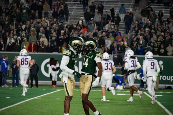 Colorado State University football players Dom Jones (7) and Tory Horton (14) knock helmets in between plays.