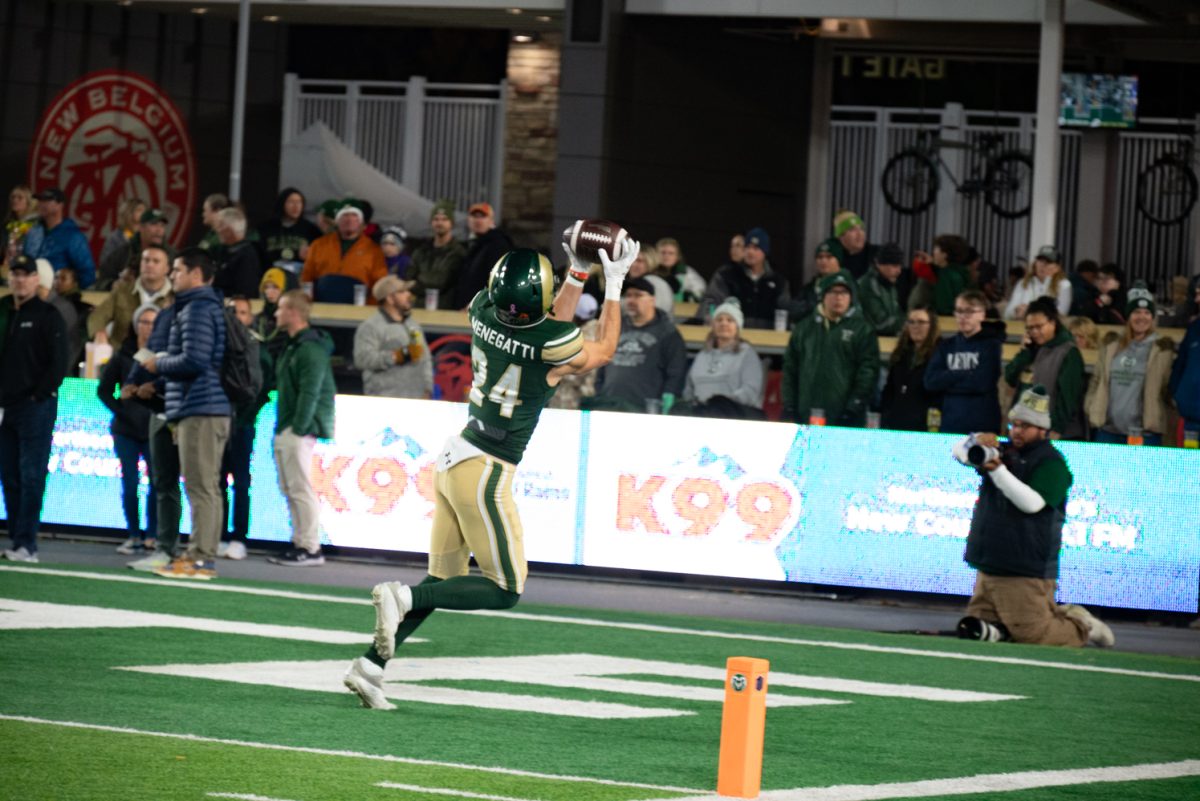 Colorado State University wide receiver Dawson Menegatti (24) catches a ball during team warm-ups.