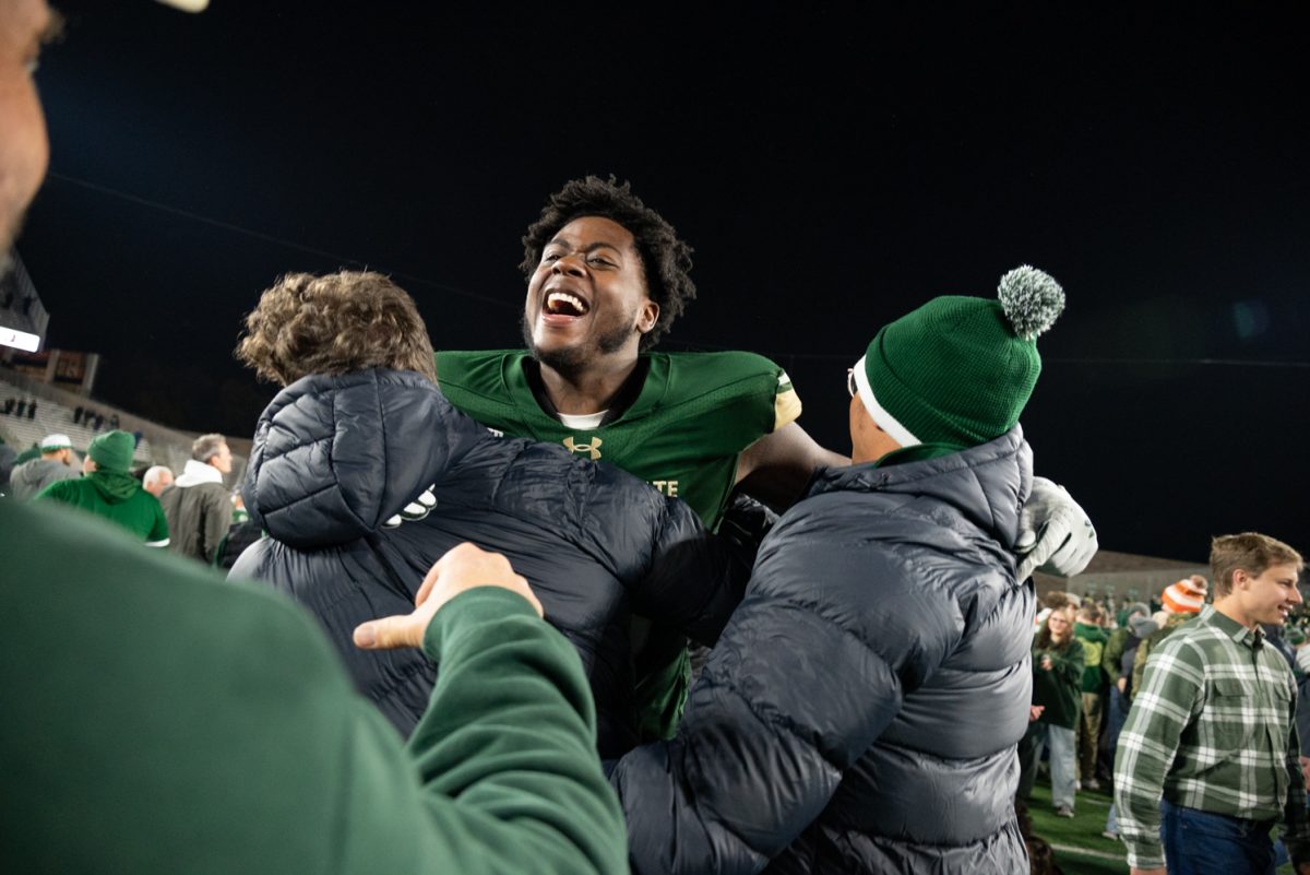 Redshirt freshman Marshon Oxley (96) celebrates with friends at the end of the game.
