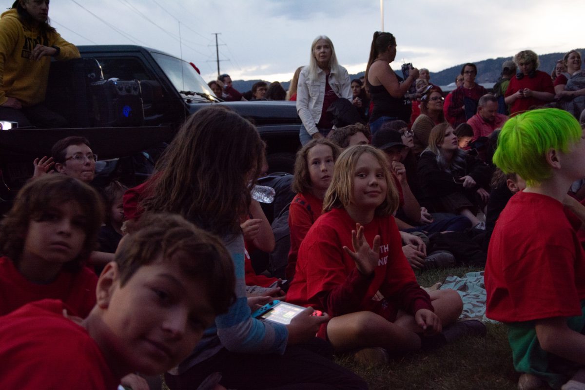 Children from Polaris Expeditionary Learning School gather outside the Poudre School District Information Technology building watching a livestream during a Poudre School District board meeting to support their school. Students and family members protested the proposed merger between Polaris and two other schools. The merger was eventually moved to be decided at a later date. 