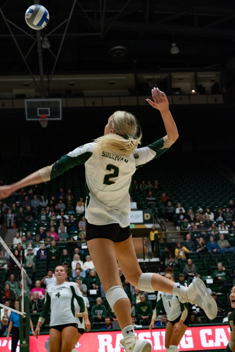 Colorado State University outside hitter Annie Sullivan (2) leaps to hit the ball.