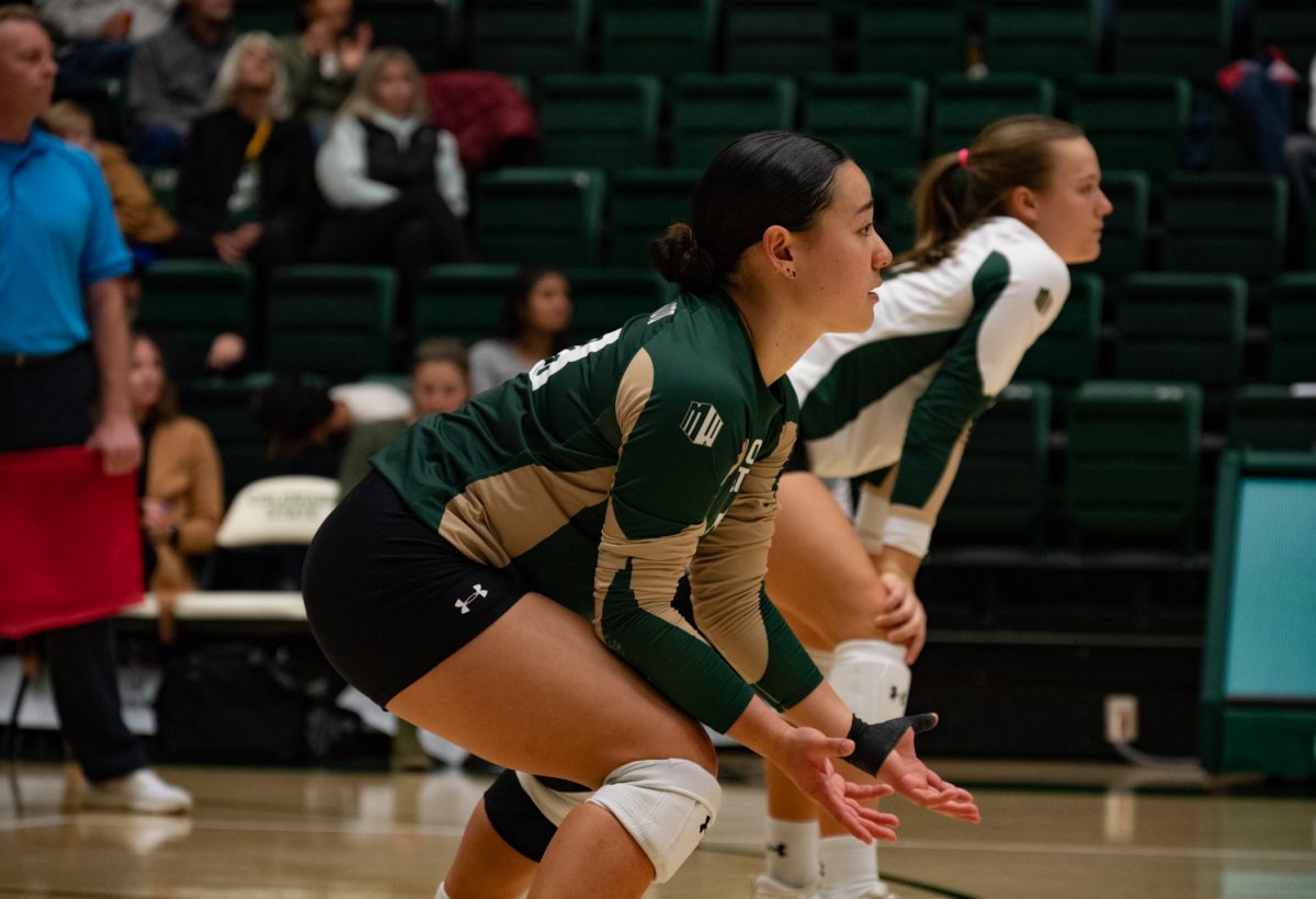 Colorado State University defensive specialist Kate Yoshimoto (18) prepares for Boise State to serve.