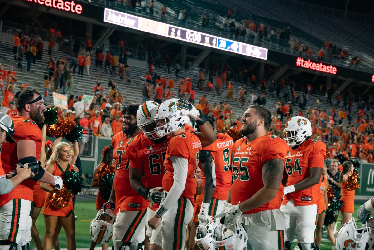 Colorado State University football players congratulate each other at the end of their game.