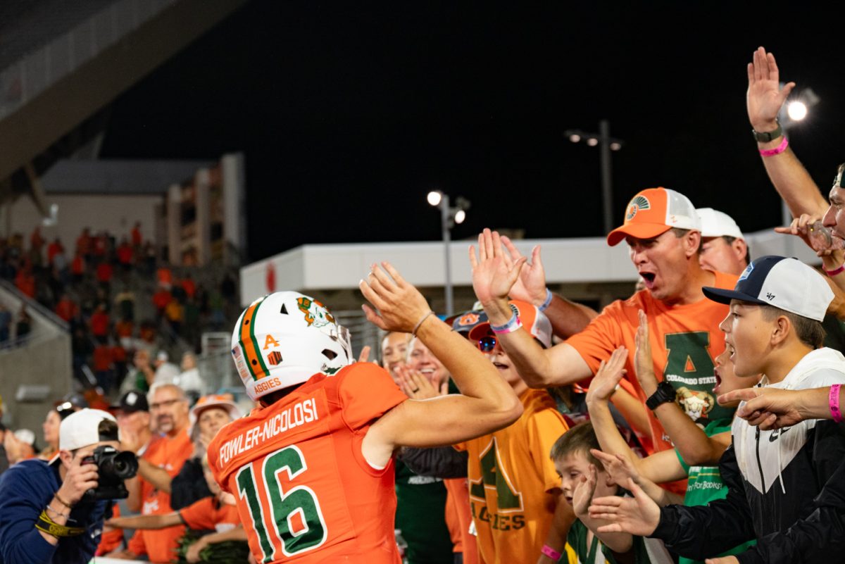 Colorado State University quarterback Brayden Fowler-Nicolosi (16) celebrates with CSU fans after the game.