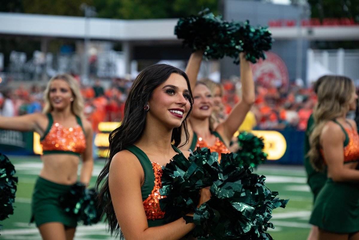 A Colorado State University cheerleader watches the crowd in between routines.