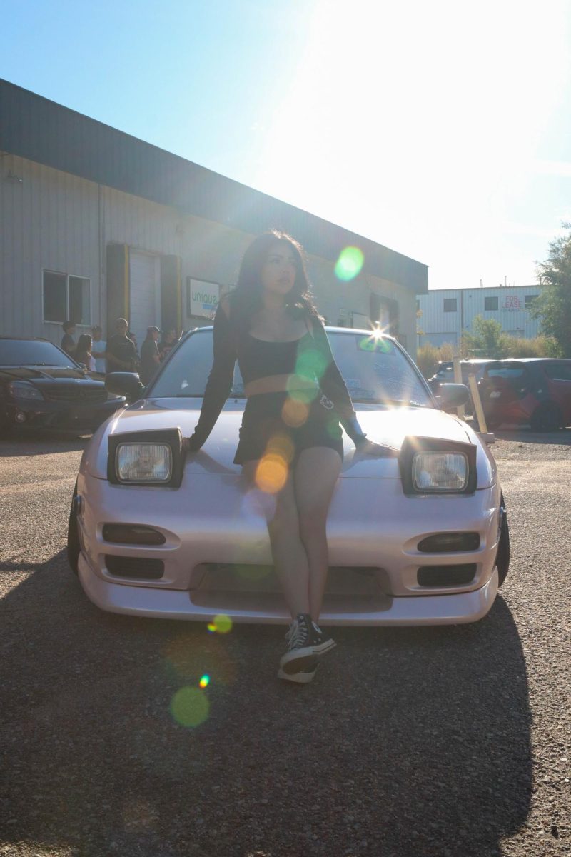 Alexa Castro poses on Travis Mccoy's 1993 Nissan 180SX at Cars and Content hosted by Juice Sept. 17.