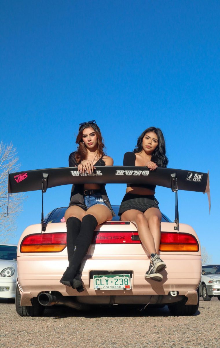 Mariah Sandoval and Alexa Castro pose on Travis McCoy's 1993 Nissan 180SX  at Cars and Content hosted by Juice Sept. 17.