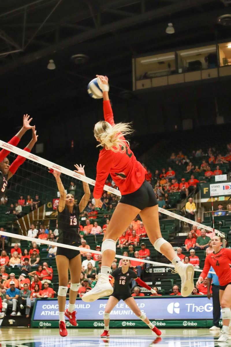 Colorado State University number 2, Annie Sullivan hits the ball over the net while University of Nevada, Las Vegas players go in to block it. CSU won, 3-0. Sept. 30.