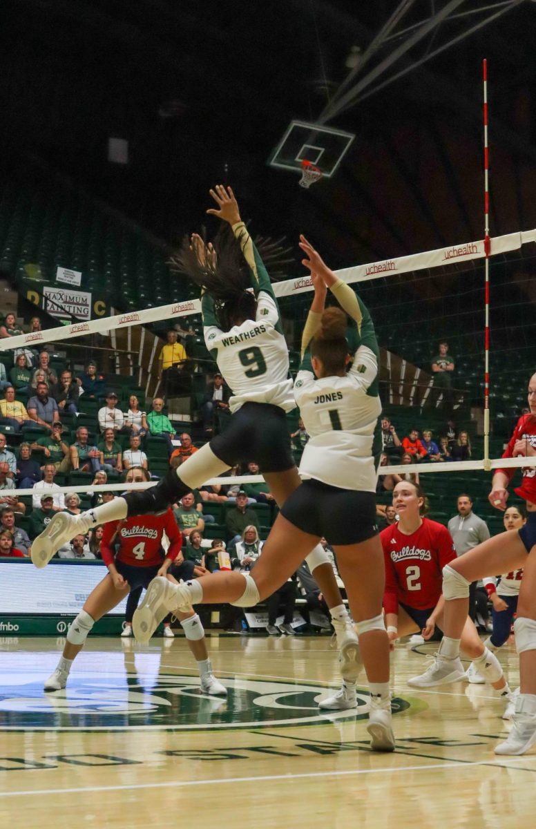 Colorado State University number 9, Maeemah Weathers, and number 1, Malaya Jones, come down from blocking the ball at the volleyball game against California State University Fresno. Fresno State won, 3-2. Oct. 19.