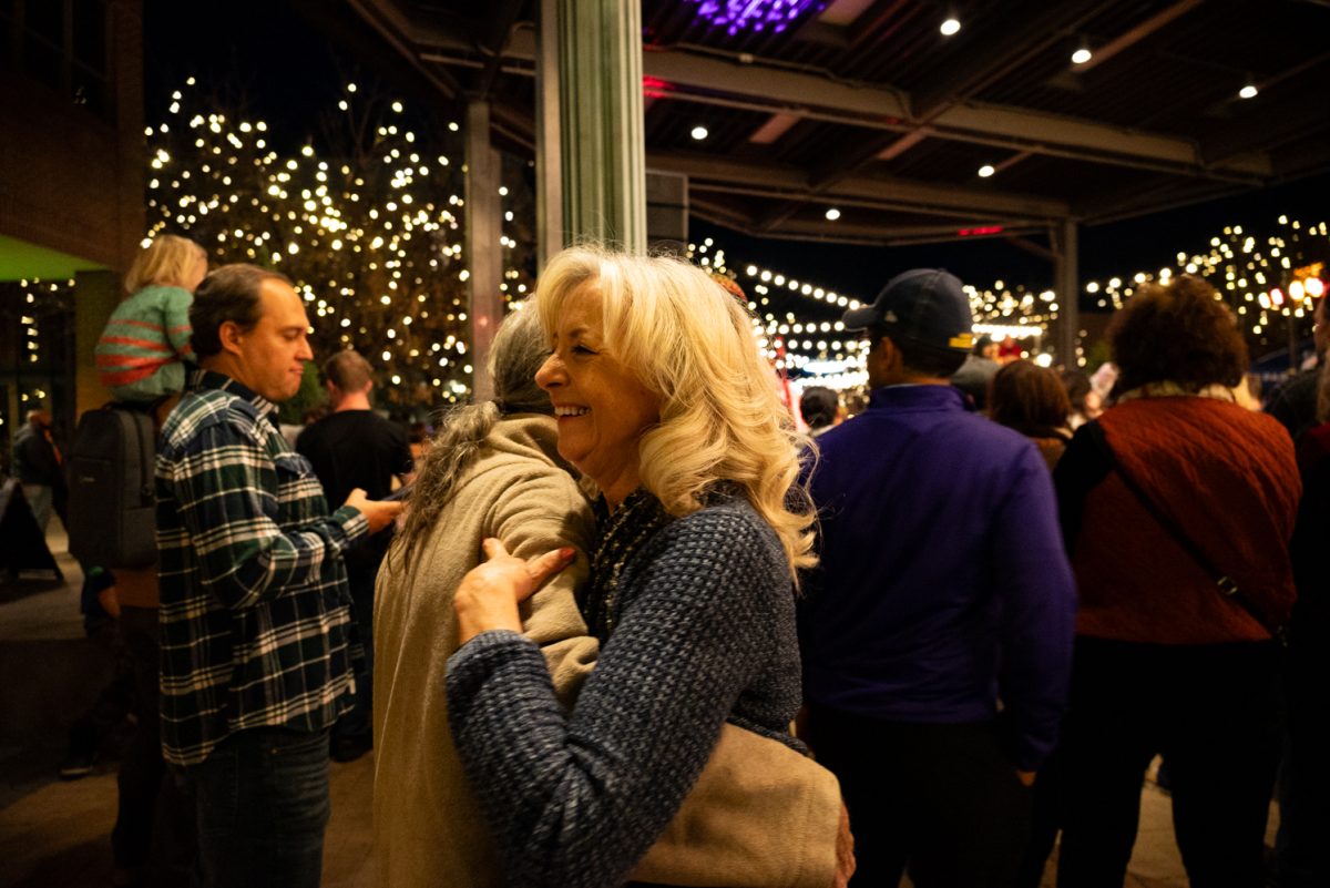 Lynn Tesson and Les Sunde embrace after a dance at the Downtown Holiday Lighting Ceremony in Old Town Square, Fort Collins.