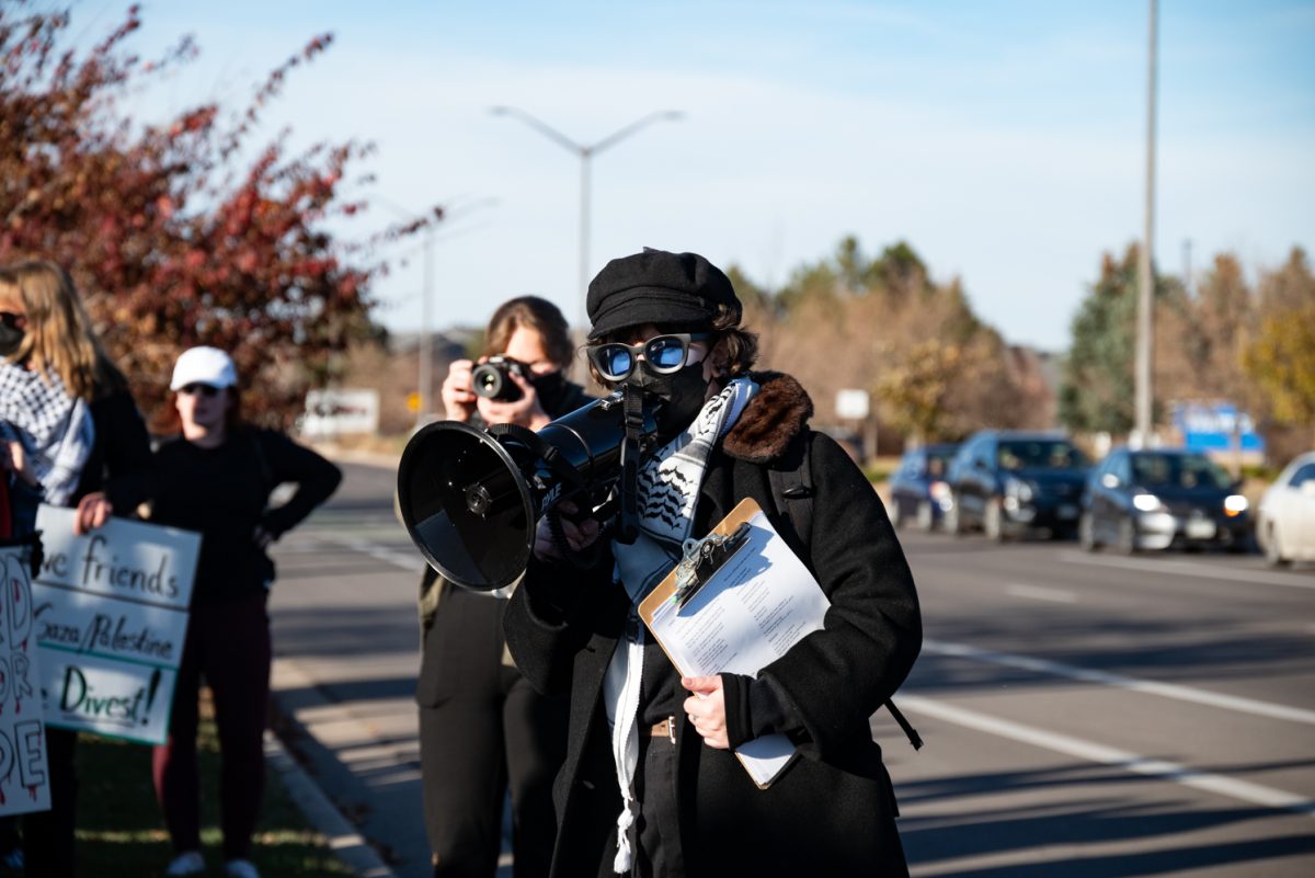 Primary organizer Nika Linn explains to protesters the goal of a 'die-in' at the "Die-In at Woodward" protest.
