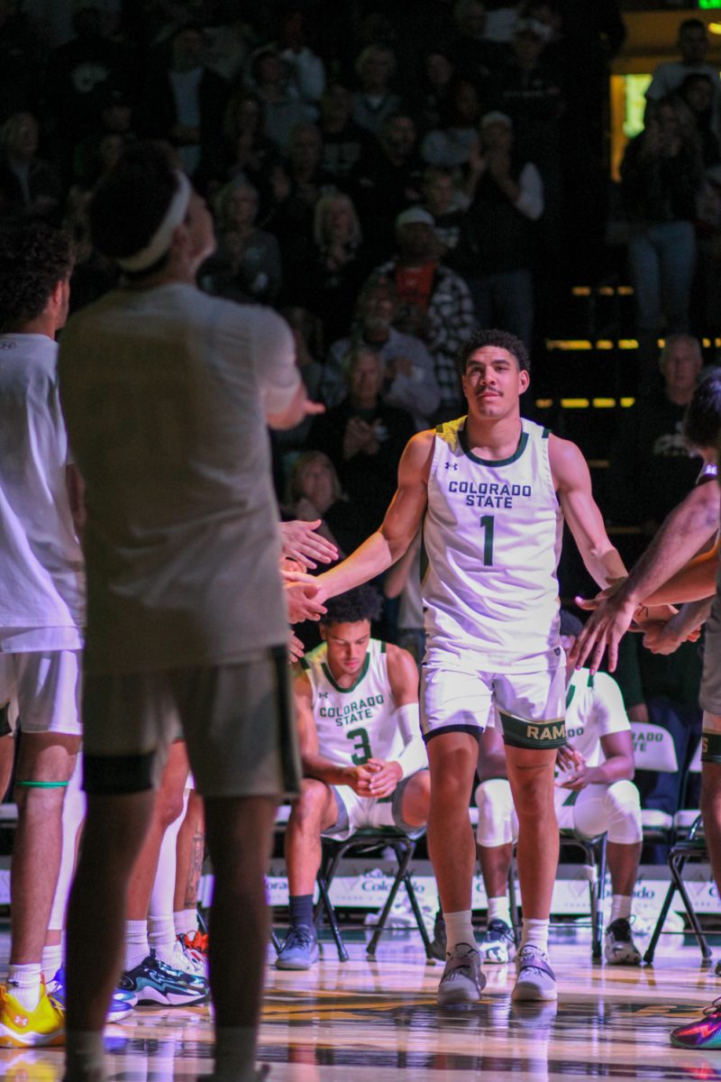 Colorado State University forward Joel Scott (1) high-fives his teammates as he is introduced to Ram fans as a CSU starter Nov. 10.