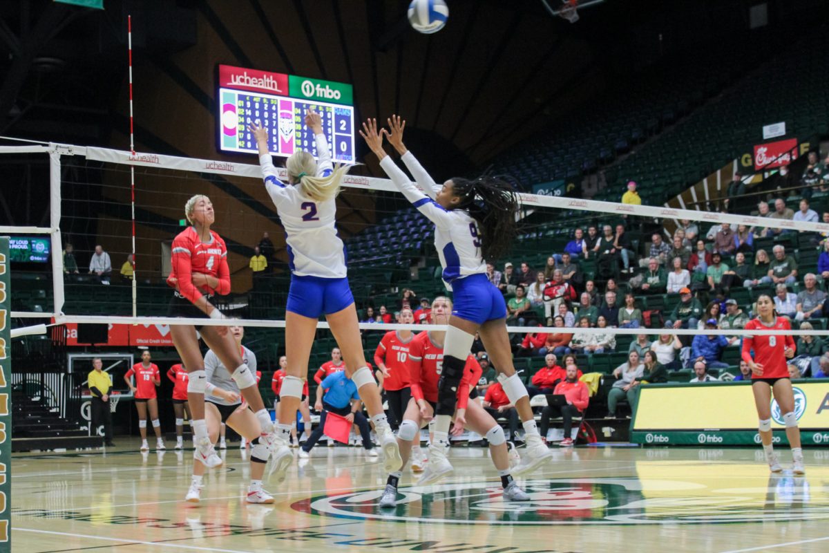 Colorado State University outside hitter Annie Sullivan (2) and middle blocker Naeemah Weathers (9) attempt to block a hit from The University of New Mexico Lobos Nov. 16.