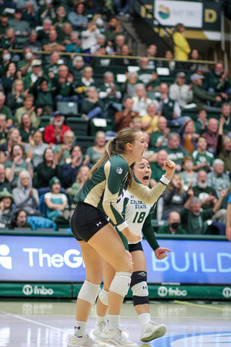 Colorado State defensive specialists Anna Porter (10) and Kate Yoshimoto (18) scream in celebration after the Rams won their second set in a row against the US Air Force Academy Nov. 18.