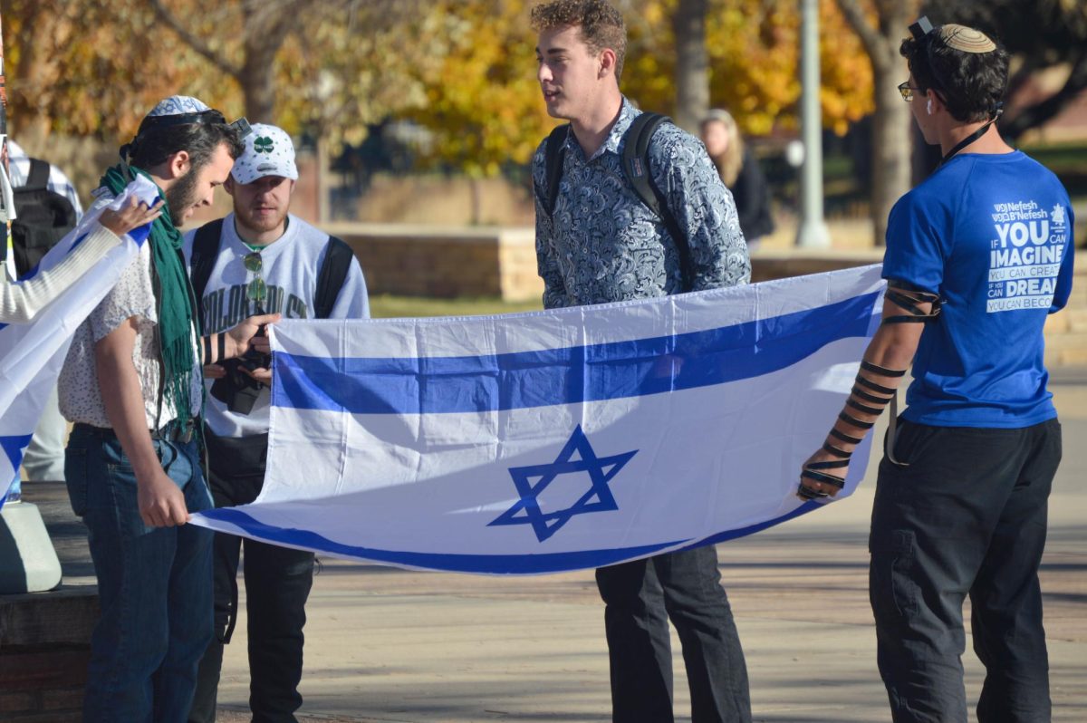 Bradley Berman and other counter protesters wave Israel flags in a counterdemonstration to the Free Palestine Protest outside the Lory Student Center Nov. 10. A few Jewish students gathered to show support for Israel in the war against Hamas. 
