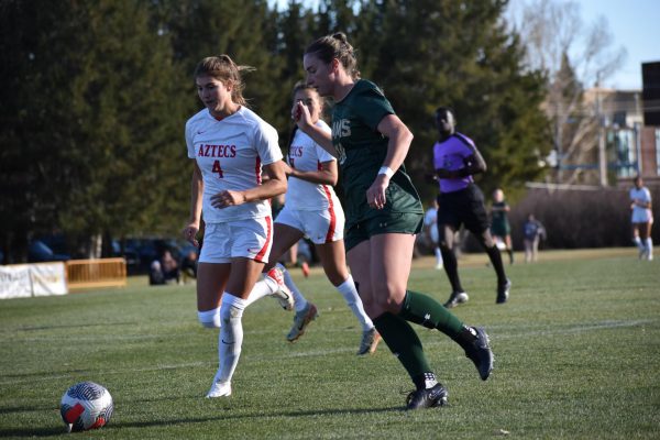 Olivia Fout (18) dribbles the ball past a San Diego State University defender in the Mountain West tournament semi-finals Nov. 1. The game ended in a 0-0 (3-2) PK win for Colorado State University. 