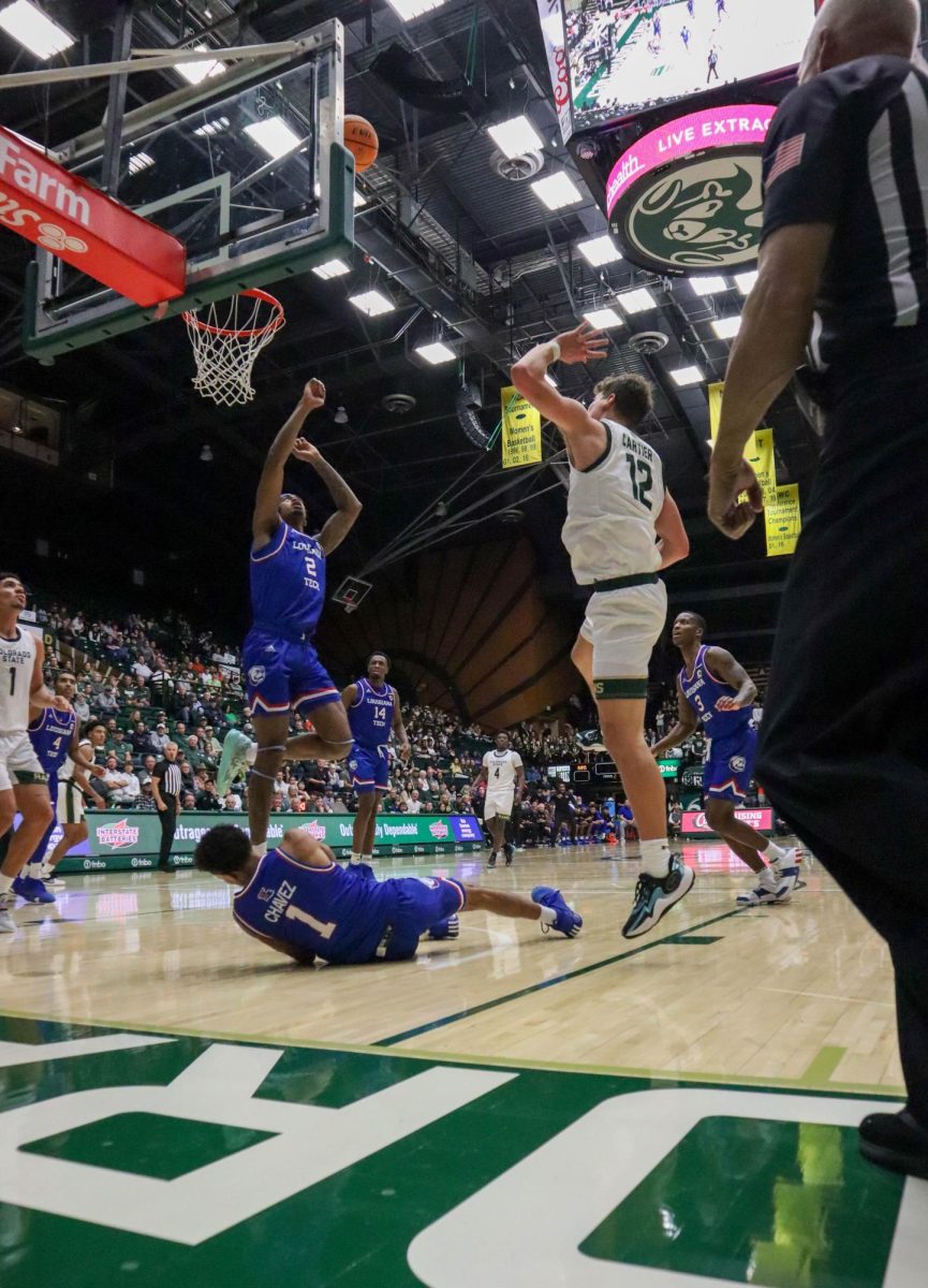 Colorado State University number 12, Patrick Cartier, shoots the ball, making a basket at the Men's basketball season opener against Louisiana Tech, CSU won 81-73.