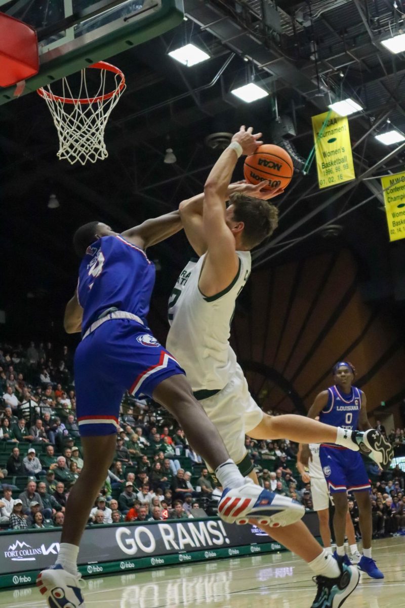 Colorado State University number 12, Patrick Cartier, jumps to make a basket at the Men's basketball season opener against Louisiana Tech, CSU won 81-73.