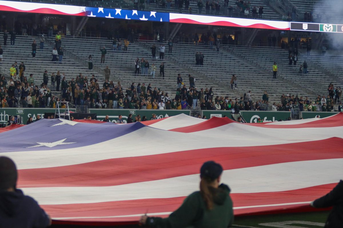 A Football field sized American Flag is stretched across the field at the military appreciation game against San Diego State University, CSU won 22-19.