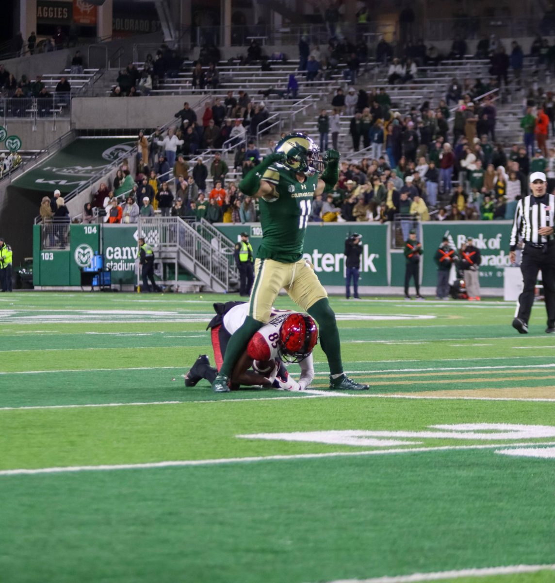 Colorado State University No.11, Henry Blackburn stands over a San Diego State University player proudly after taking him to the ground at the military appreciation game against San Diego State University, CSU won 22-19.