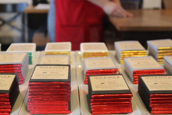 Stacks of colorfully wrapped chocolate bars decorate the display case in Nuance chocolate.