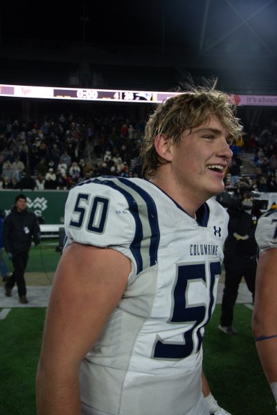 Junior Peyton Burcar walks off of the field with a grin on his face after his team wins state champions. (Columbine wins 28-14)