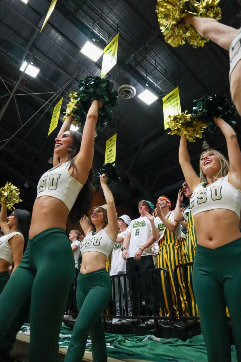 Colorado State University Golden Poms and student section cheer on the men's basketball team at the game against Denver University, CSU won, 90-80.