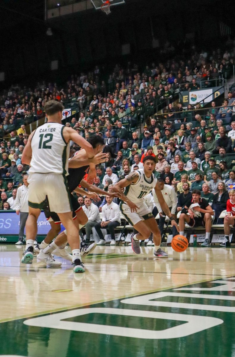 No. 10, Nique Clifford dribbles the ball past Denver University's defense at the men's basketball game against Denver University, CSU won, 90-80.