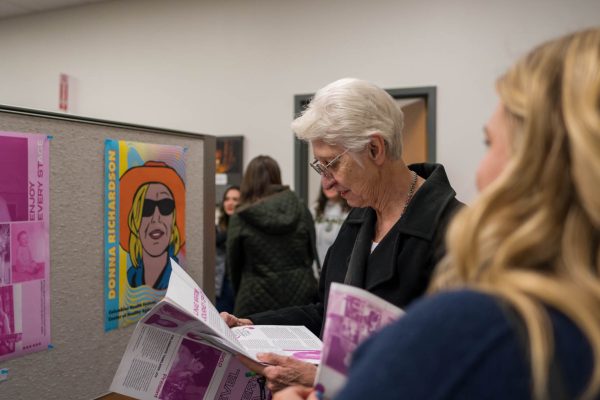 A visitor flips through the zine of Logan Honeas poster design at the Colorado State University Center for Healthy Aging Jan. 23. The Art and Aging Exhibition is in its second year with the goal to combine science and art while bringing awareness to issues of aging.