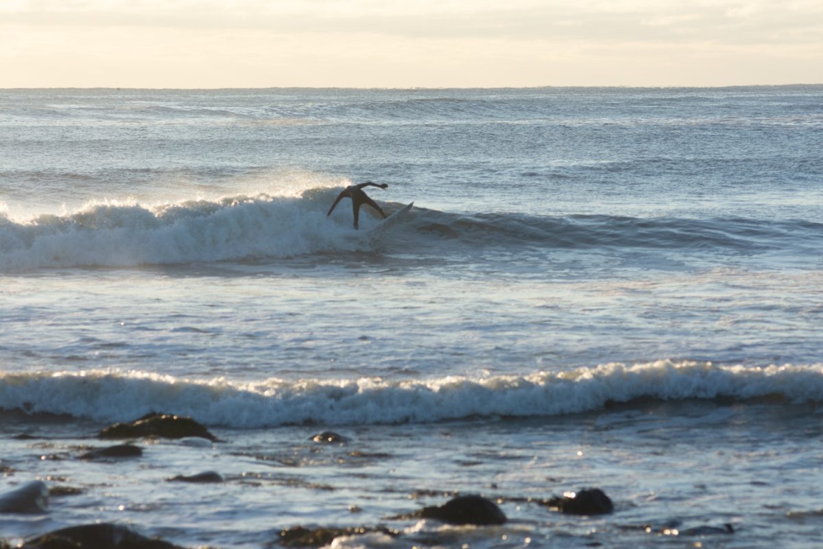 A Surfer goes in for a 360 during his morning surf session at Bass Beach in Rye, New Hampshire. (Dec 20,2023)