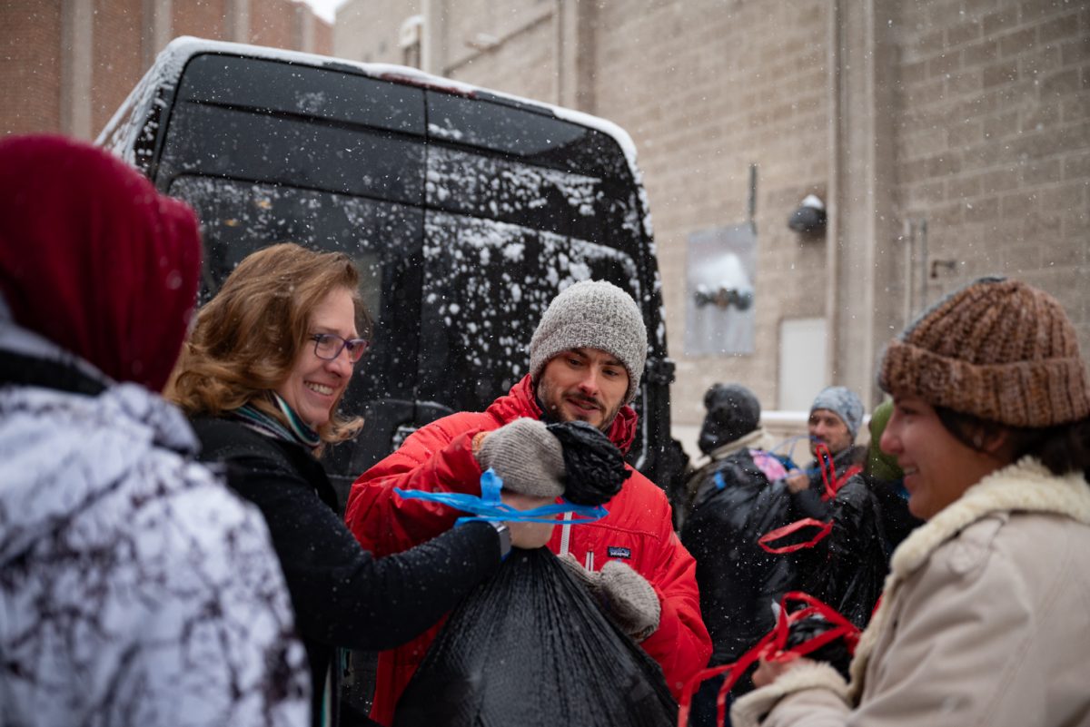 Larimer County Commissioner Jody Shadduck-McNally and other volunteers help load bags of donated clothes into a van at the Day of Service for Martin Luther King Jr. Day.