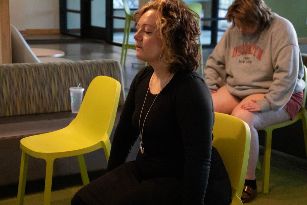 Eve Montoya stretches during seated wheelchair accessible yoga in the Aggie Village Lodgepole lobby on January 29, 2024.