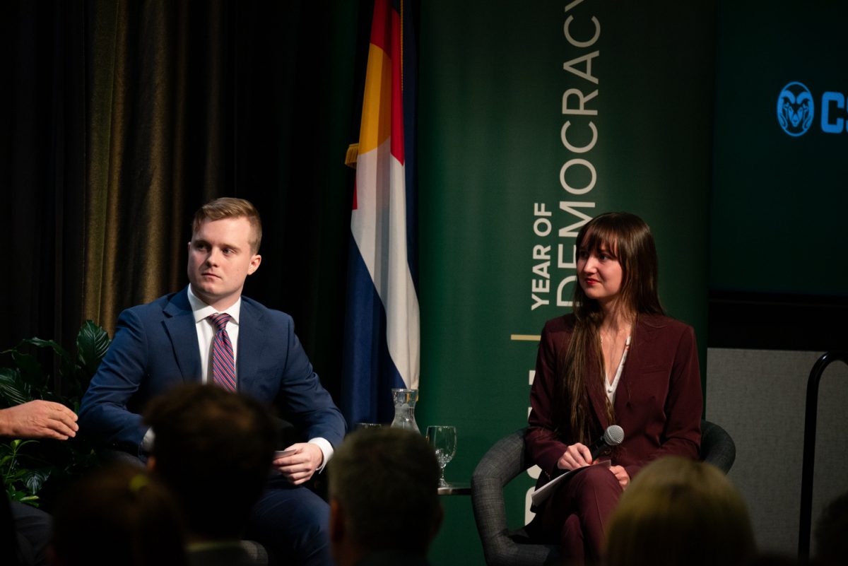 Student moderators Jack Barrett and Amber Wright listen to Representative Ken Buck during the Coffee with Ken Buck event in the University Ballroom.