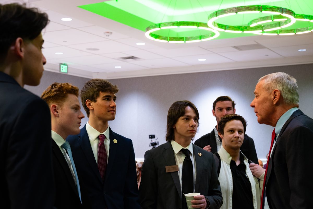 Representative Ken Buck takes a moment to speak with student body president Nick DeSalvo and other members of the Associated Students of Colorado State University before going on stage.