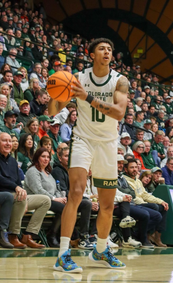 No. 10, Nique Clifford observes the court to pass the ball in the basketball game against the Air Force Academy, CSU won in overtime 78-69.